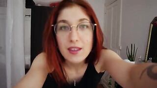 Redhead Trish Collins tries on sexy lingerie and teases in the bedroom