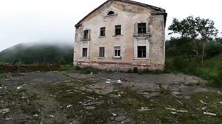 An exhibitionist girl is walking around horrible buildings with her sexy babe