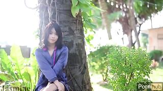An Asian girl masturbates with a dildo and vibrator in the garden