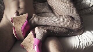 A sexy girl in stockings and high heels is touching herself