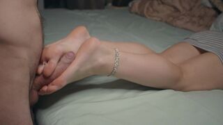 A petite beauty shows her small feet and performs a footjob