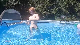 Redhead in red bikini underwater, ignoring the failed tanning