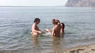 Three naked beauties on the beach with a stunning view