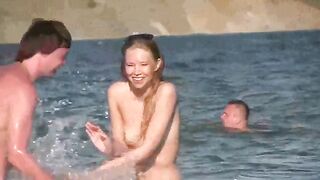A mature woman is completely naked on the beautiful beach