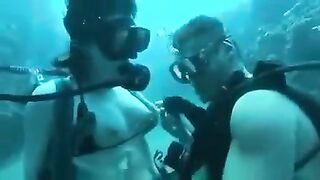 Aqualangists are having fun at the bottom of the sea in this hot video