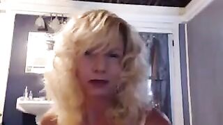 Aged lady has fun in the bathroom with a toy