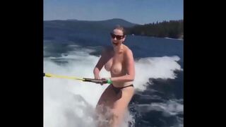 Topless girl skiing on the water surface