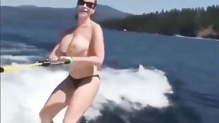 Topless girl skiing on the water surface
