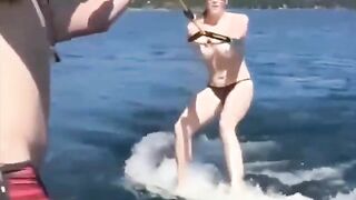 Topless girl skiing on the water surface