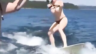 Topless girl skiing on the water surface