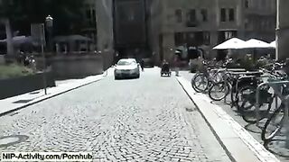 A girl has a playful walk and shows her boobs to the public