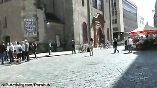 A girl has a playful walk and shows her boobs to the public