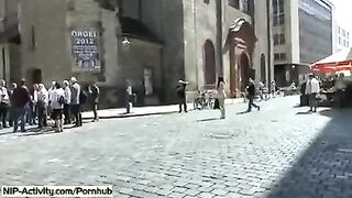 A girl has a playful walk and shows her boobs to the public