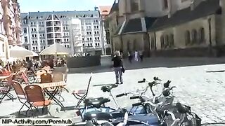 A girl has a playful walk and shows her boobs to the public