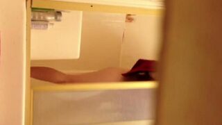 A girl has sex in the shower, not suspecting that she is being watched