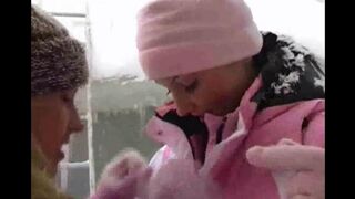 Two girls are having fun on a cold and snowy day