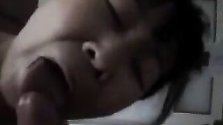 An adult Chinese woman practices her blowjob skills on him, showcasing passion