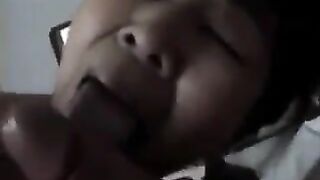 An adult Chinese woman practices her blowjob skills on him, showcasing passion