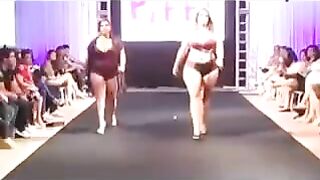 Some fat women are running on the boardwalk and playing with their bodies in swimsuits