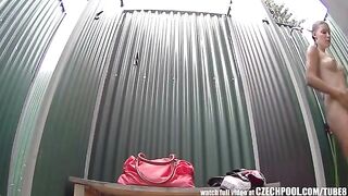 A girl washes her body in the shower and notices a camera