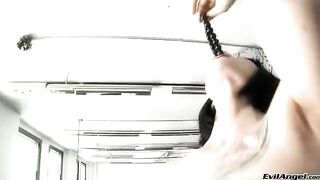 The girl wears sexy high heels and plays with her pussy ball