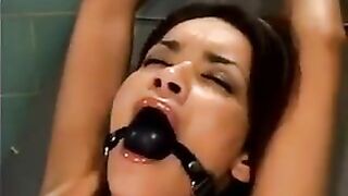 A bald guy is having his way with a young girl on a sex machine