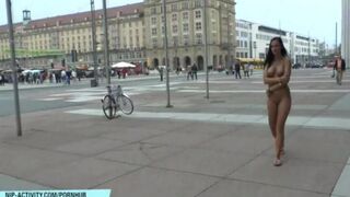A hot girl is walking naked on the city streets and showing herself