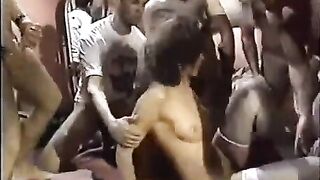 A young whore is having fun in a circle with guys
