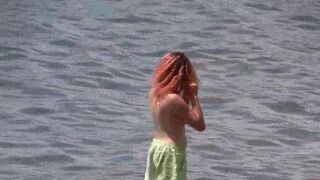 A sexy girl is walking naked on the coast of Crimea