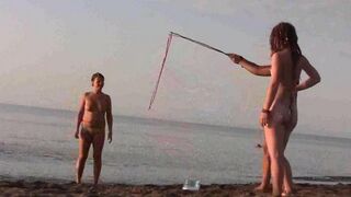 A hot naked chick is fucking on the beach