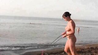 A hot naked chick is fucking on the beach