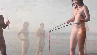 A hot naked chick is fucking on the beach