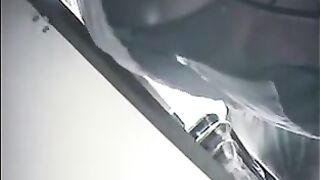 The camera is hidden at the checkout in the store and shoots up skirts