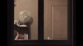 He admires himself in the mirror, standing completely naked in front of it