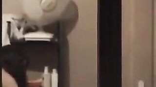 He admires himself in the mirror, standing completely naked in front of it