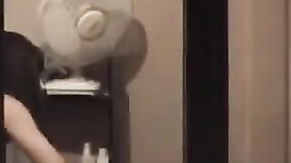 He admires himself in the mirror, standing completely naked in front of it