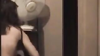 He admires himself in the mirror, standing completely naked in front of it