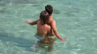 Girl fingers a guy’s cock while they’re underwater