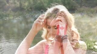 A hot blonde has sex with herself on the lake