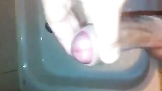 The kid masturbates his dick with his hand while taking a shower