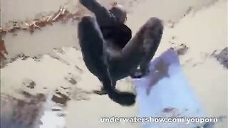 A sexy girl is floating naked in the swimming pool