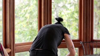Vietnamese girl in the kitchen has sex with her girlfriend using a strap-on