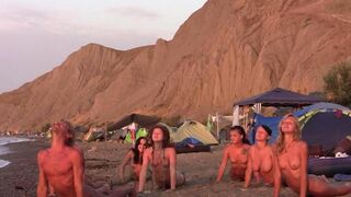 A group of naked beauties play volleyball on the beautiful beach