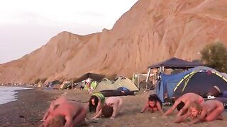 A group of naked beauties play volleyball on the beautiful beach