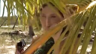 A couple engages in passionate fun on the sandy beach, getting noticed