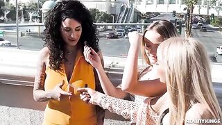 A couple of lesbians are having fun on the strip with another girl