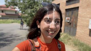 A sexy girl is making a blowjob in the street and gets a huge cumshot on her face
